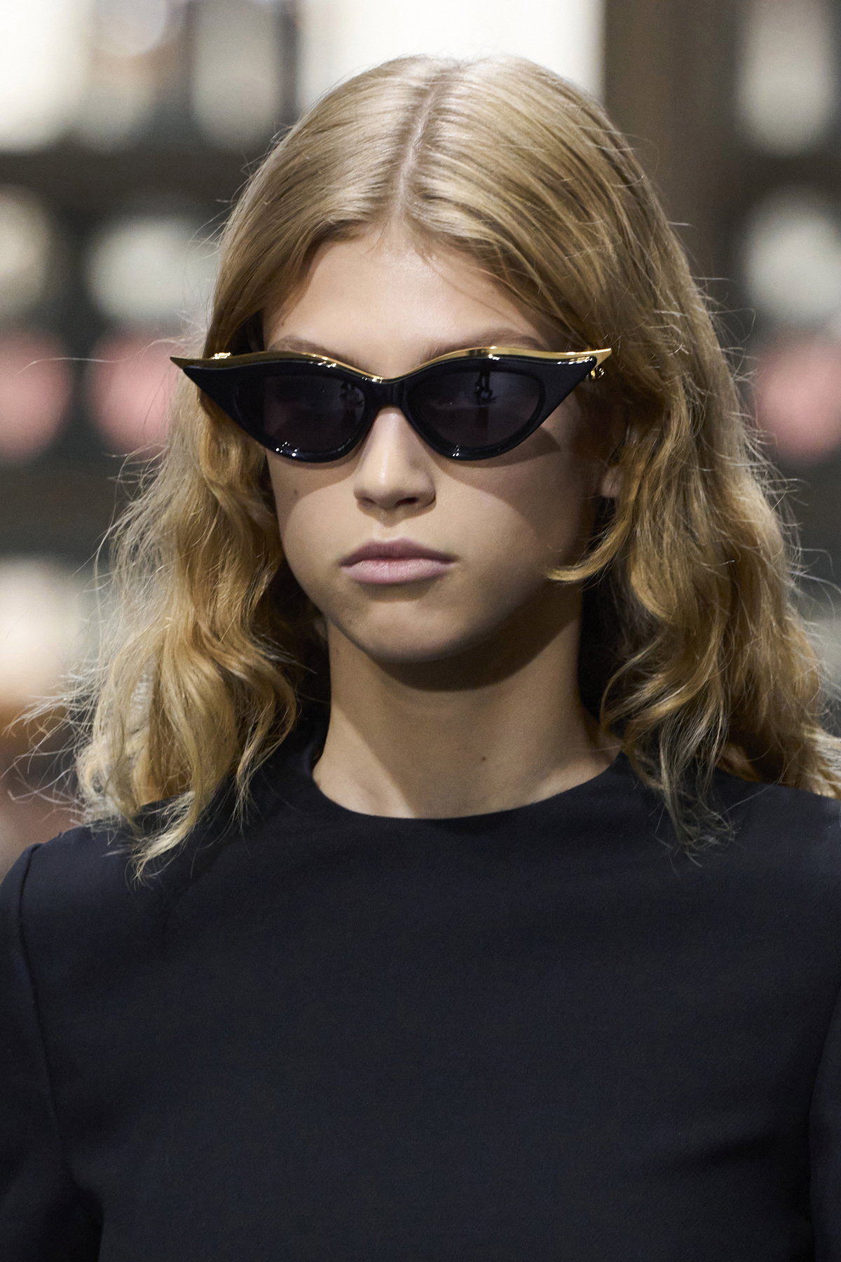 Frau mit Sonnenbrille und Stufenhaarschnitt