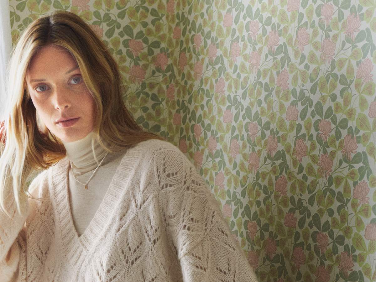 Model in gestricktem Ajourpullover