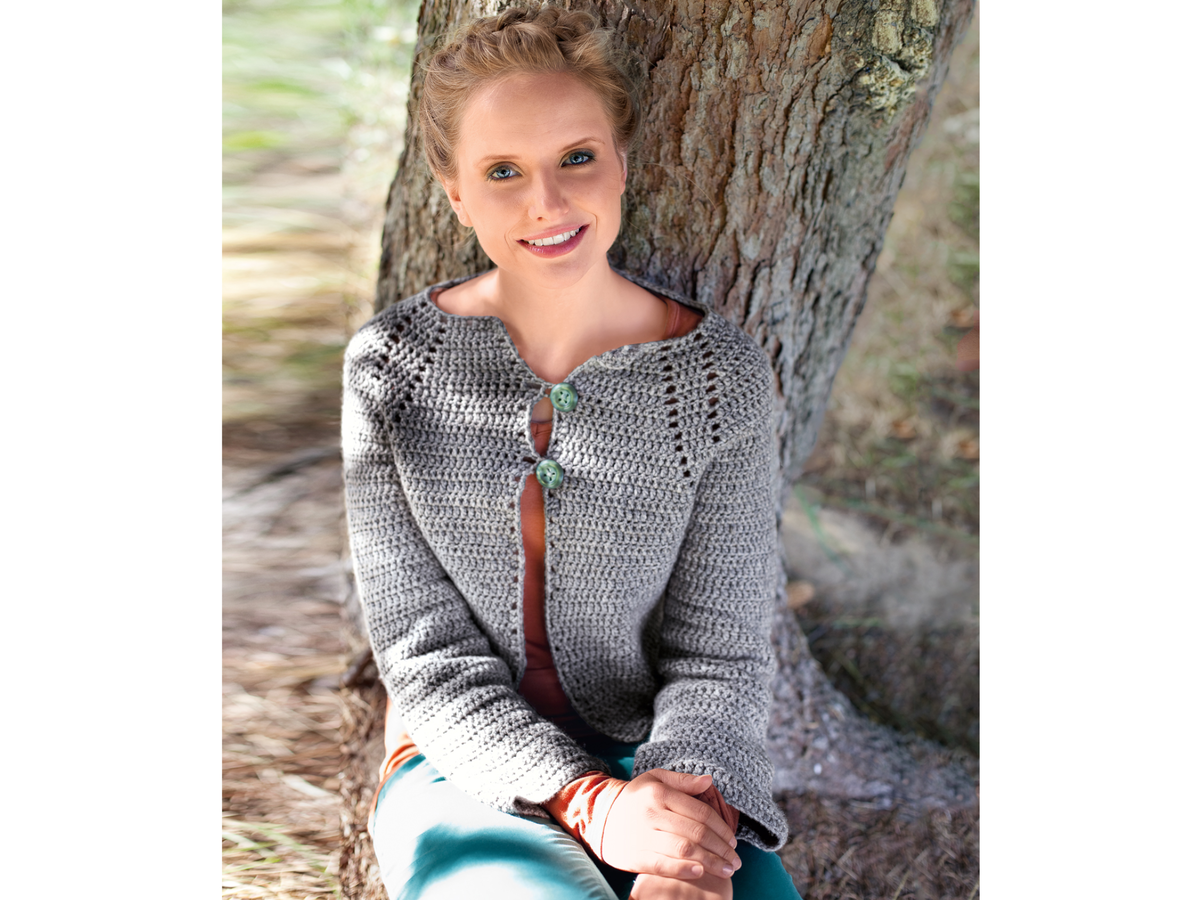 Model in grauer Häkeljacke mit Knöpfen