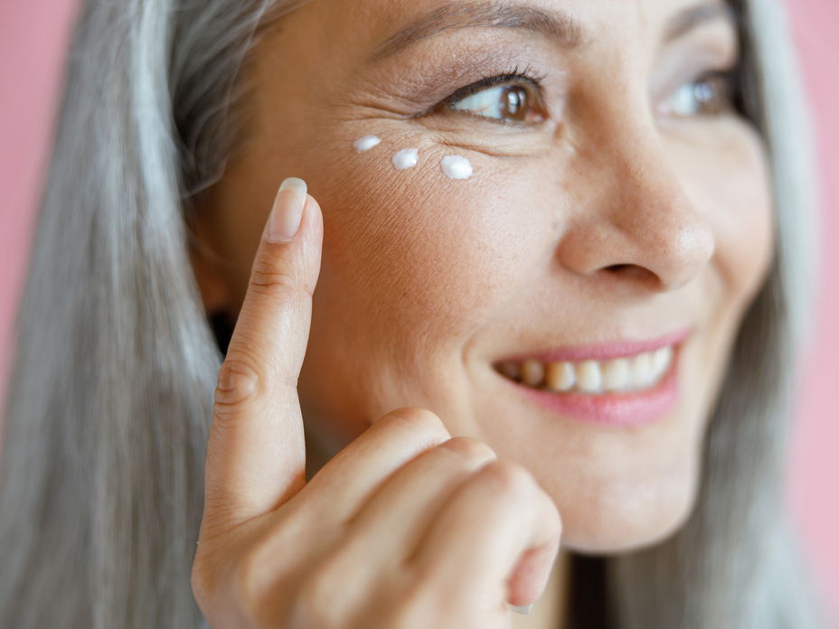 Ältere Frau mit Augencreme