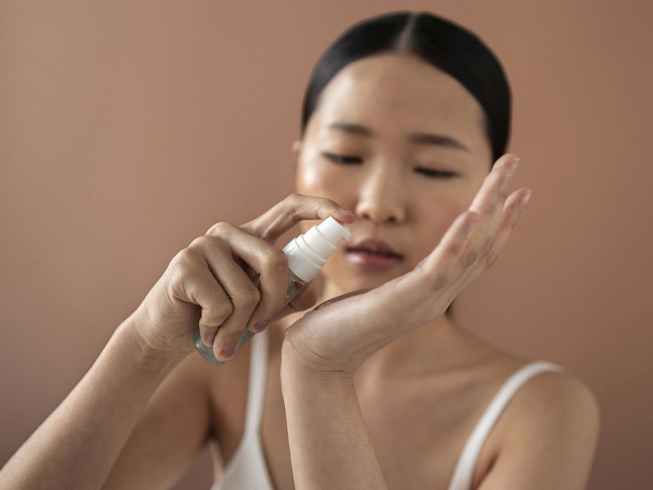 Asiatische Frau verwendet Serum